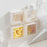 Adhesive flip storage box, wall-mounted, for small items